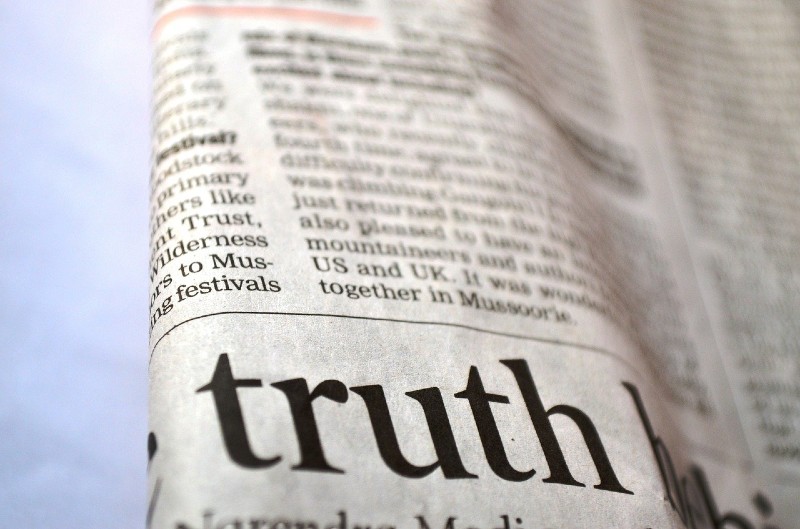 Photo of a newspaper that focuses on the word "truth"