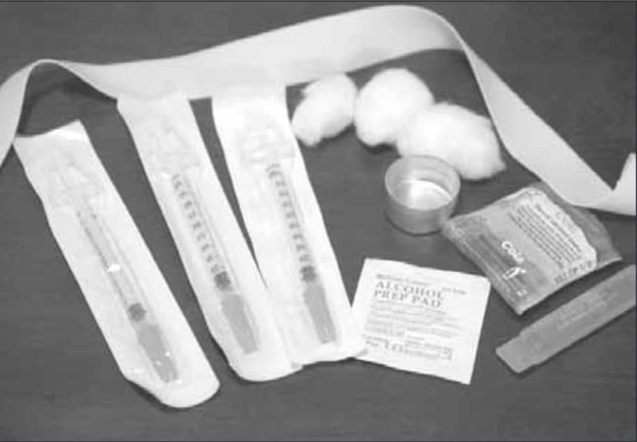 Image of sealed injection needles and alcohol prep pads and other medical supplies.