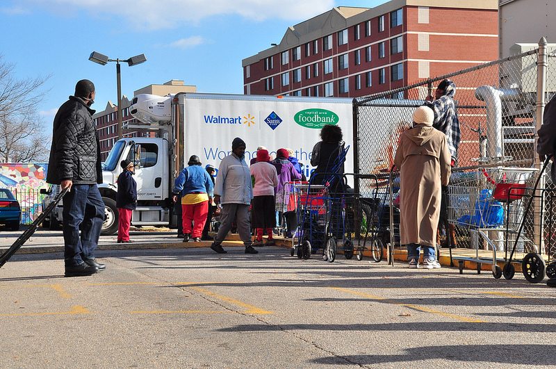 People lining up at a food bank truck.