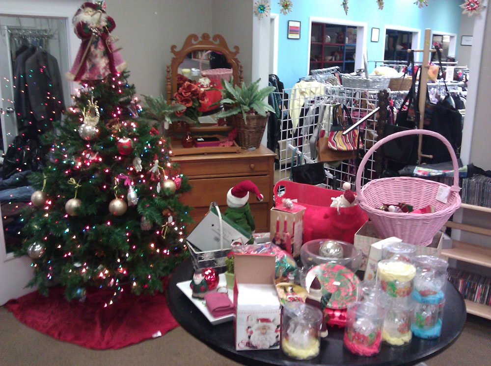 A Christmas tree in the center of a thrift store.