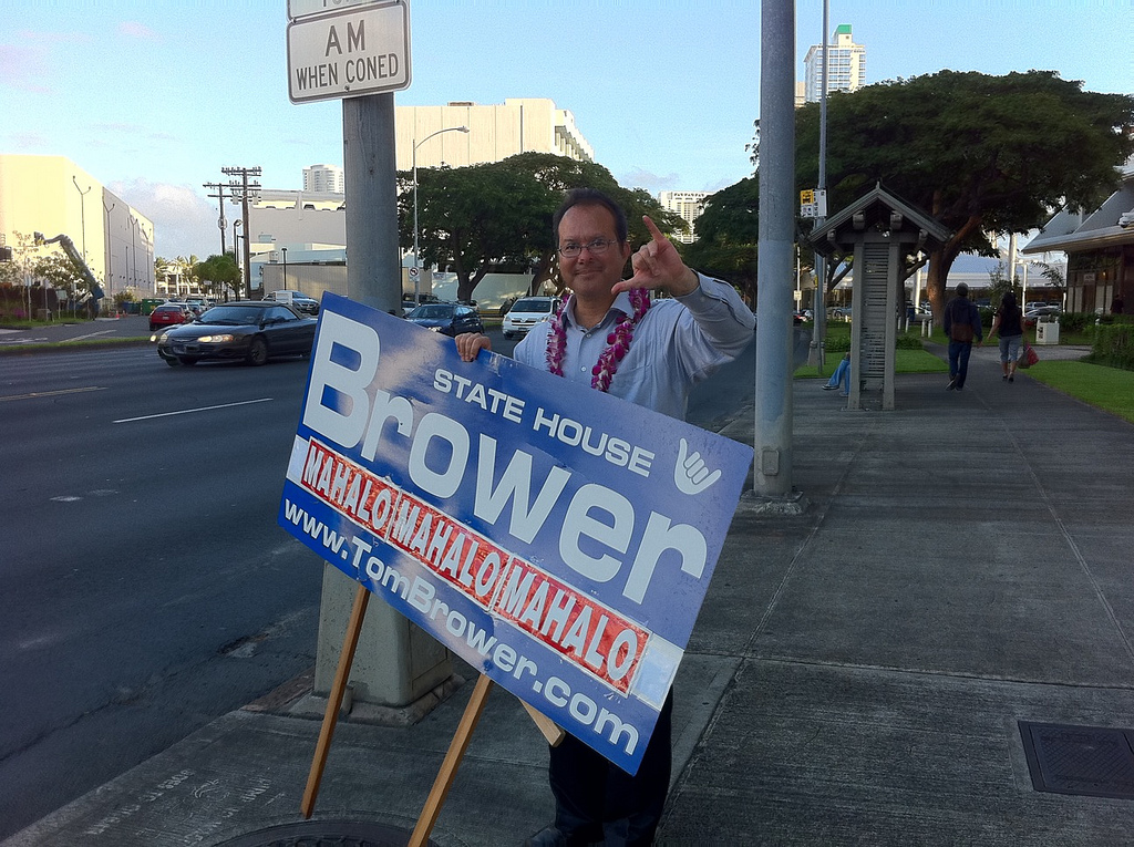 Tom Brower holding senate race sign