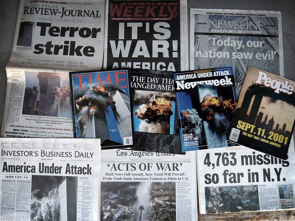 a photo of newpapers which is covering with 9/11