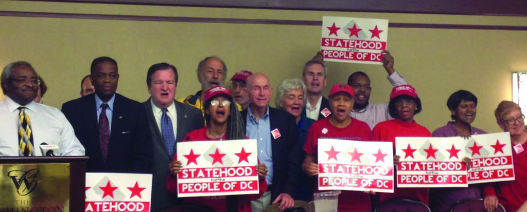 a photo of Attorney Johnny Barens standing with supporters of DC Statehood