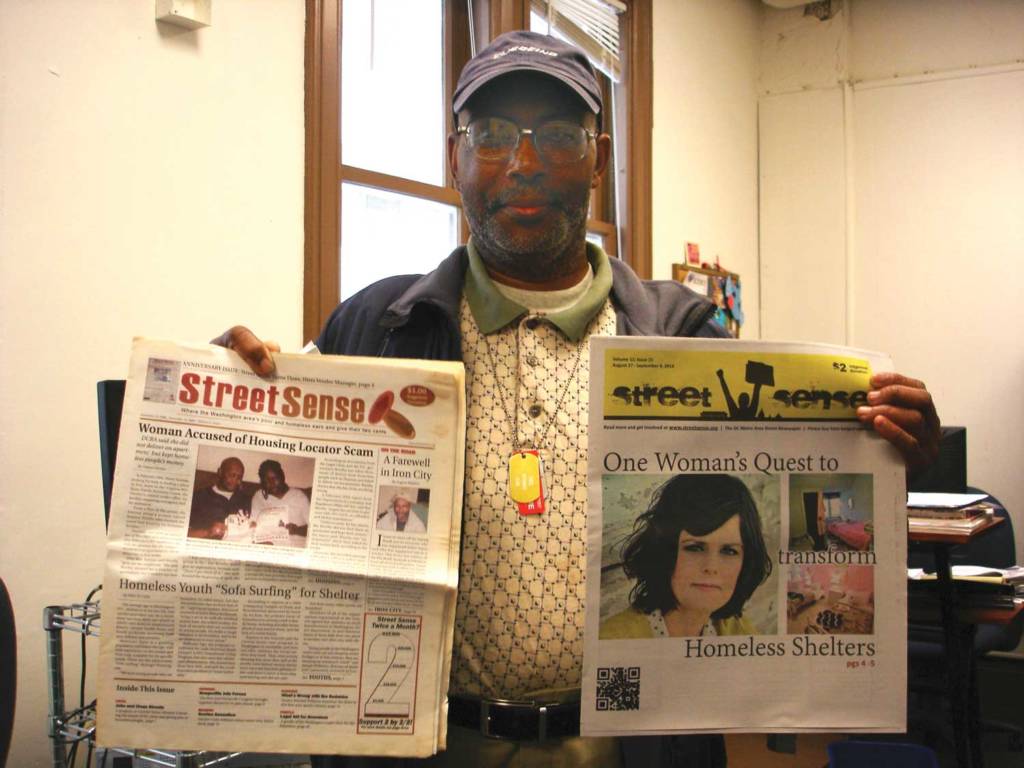 Picture of August Mallory holding up a 2008 and a 2014 issue of Street Sense.