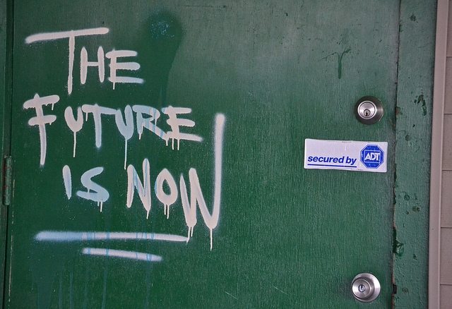 a photo of green wall with a phrase "The Future is Now"