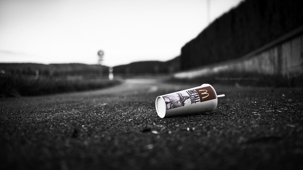a photo of an abandoned cup on the street