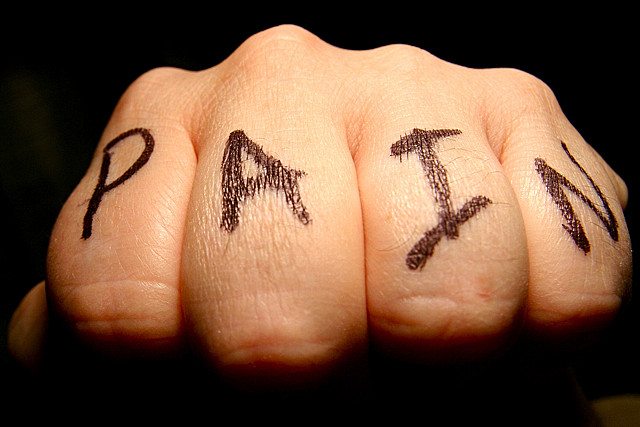 a photo of a blow fist with the words "PAIN"
