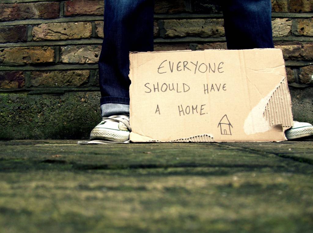 Photograph of cardboard sign saying "Everyone should have a home"
