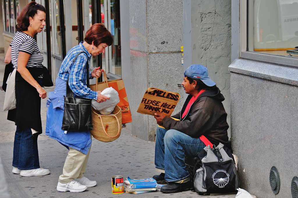People helping a homeless person