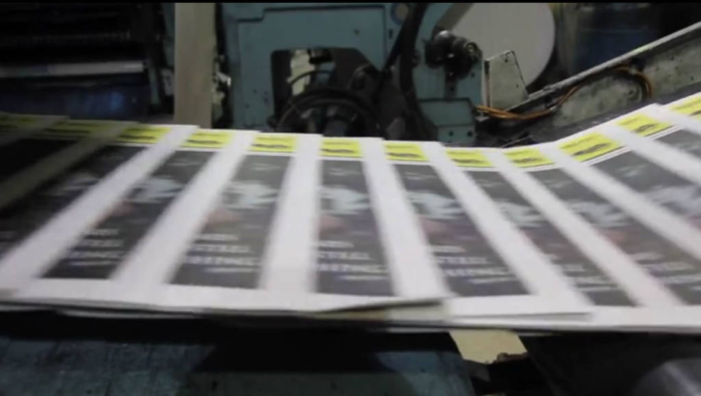 Photo of newspapers coming off the presses