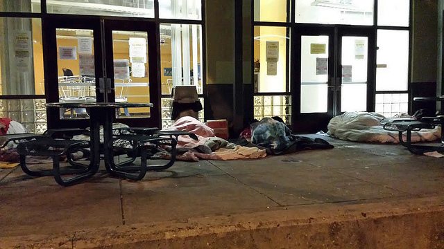 People sleeping on sidewalk