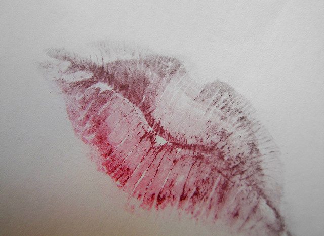 Image of a lipstick kiss on a white paper.