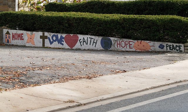 Image of a sidewalk with the words "Home" "Love" "Faith" "Hope" and "Peace".