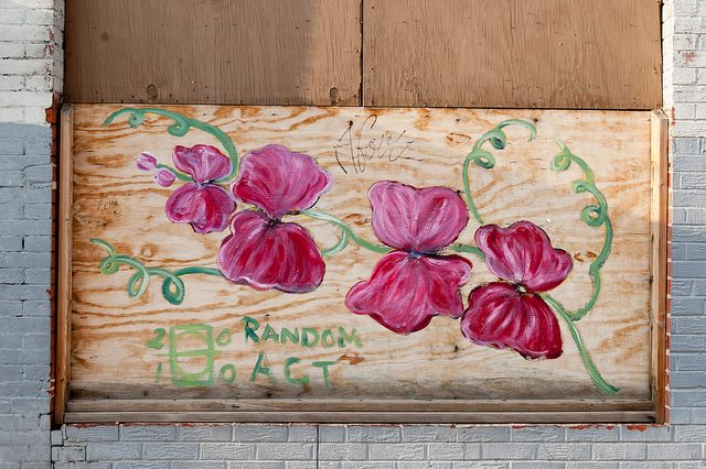 Picture of a wooden board with pink flowers painted on it.