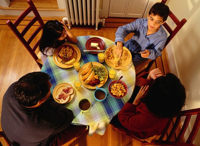 Image of a family gathered around a dinner table.