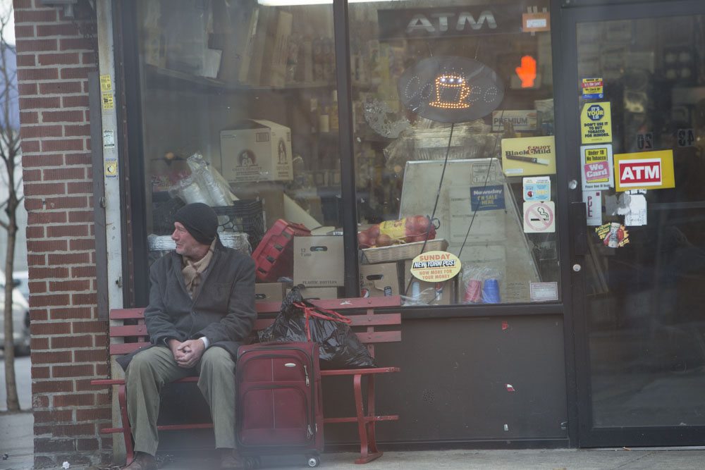 A still image from the film Time Out of Mind, George Hammond (Richard Gere) sits outside on a bench.
