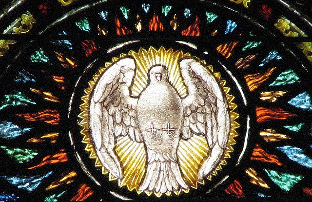 Image of the Holy Spirit on stained glass.