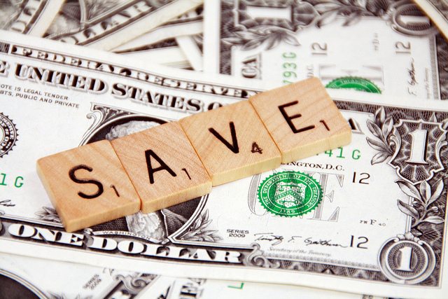 Image of the word "Save" on a pile of 1 dollar bills.
