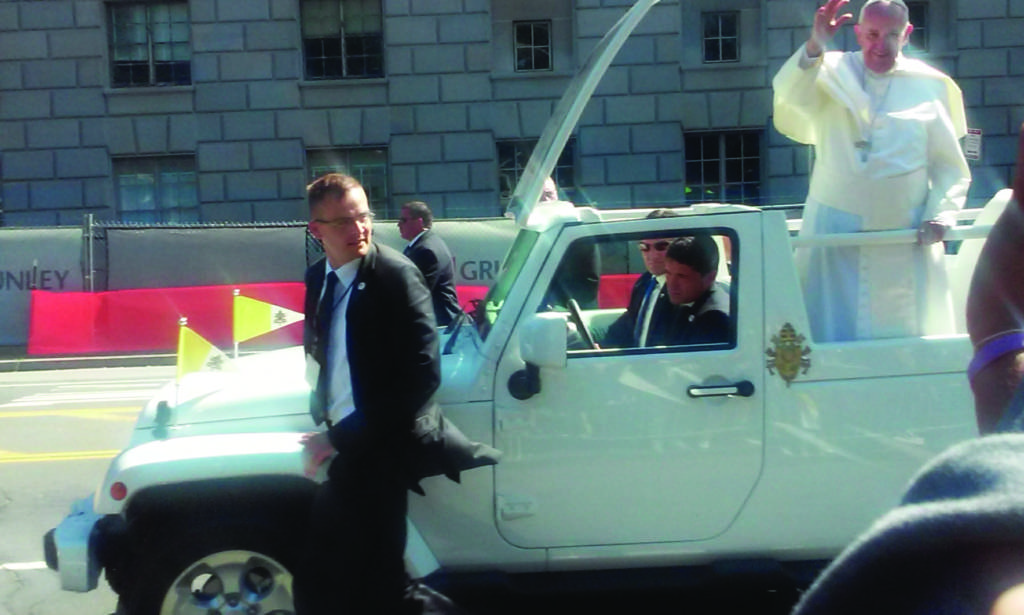 Image of Pope driving past in an automobile.