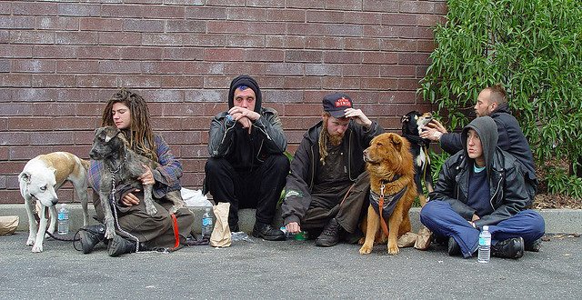 Image of five homeless men with their 4 dogs.