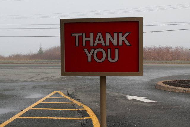 Image of a sign on a road that says "Thank you."