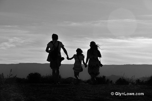 Image of family skipping on a field.