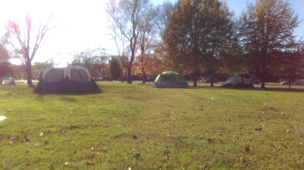Photo of 4 tents that are part of a larger encampment of homeless people in Foggy Bottom DC.