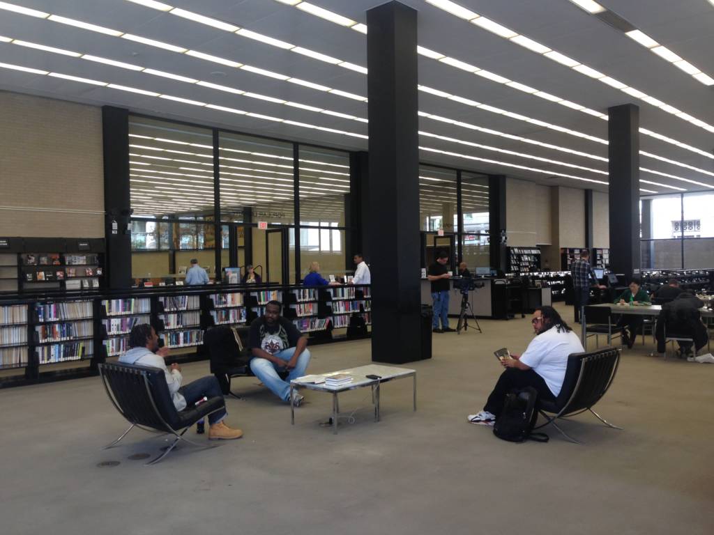 Photo of three library patrons utilizing a lounge area at Martin Luther King Jr. Library.