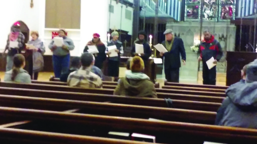 Members of the Staging Hope theater group sing at the memorial service held on January 7