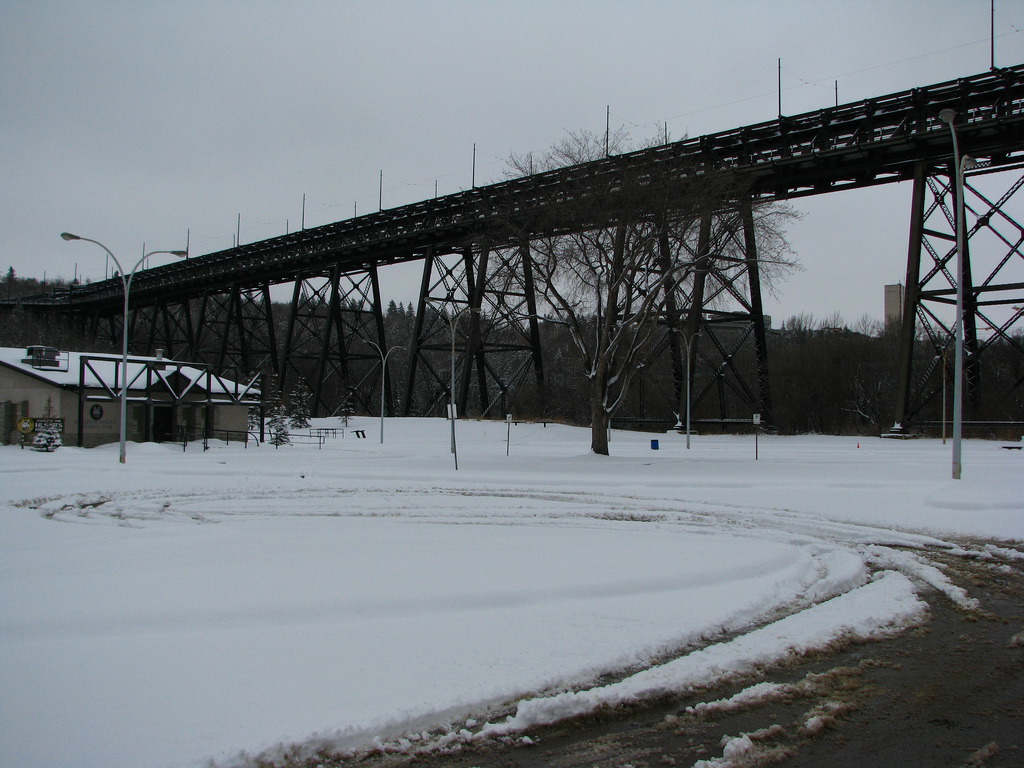 A bridge over a snowy field.