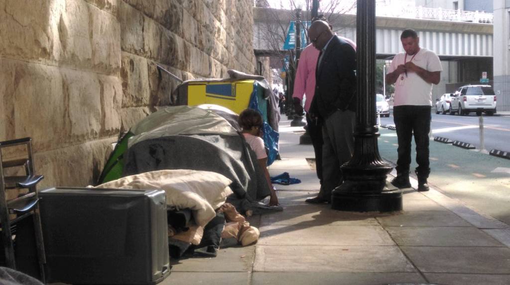 Photo of a D.C. outreach worker approaching a tent to speak with the resident who lives there.