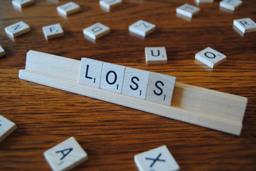 Scrabble tiles spelling out the word "loss."