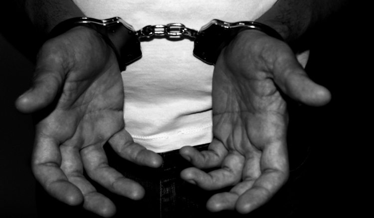 A photo of a person in handcuffs