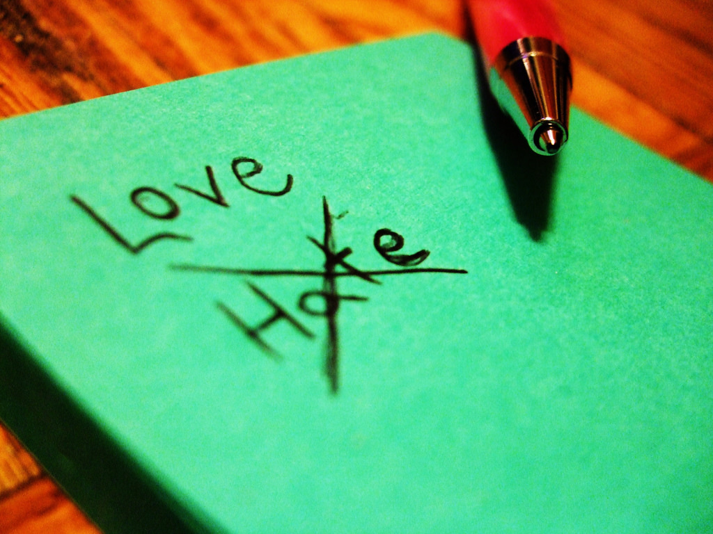 Photo of a note. The word "hate" is crossed out and the word "love" is written.