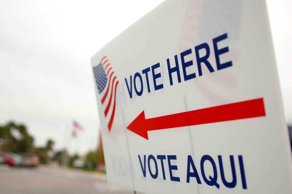 Sign saying "Vote here" and "Vote Aqui"