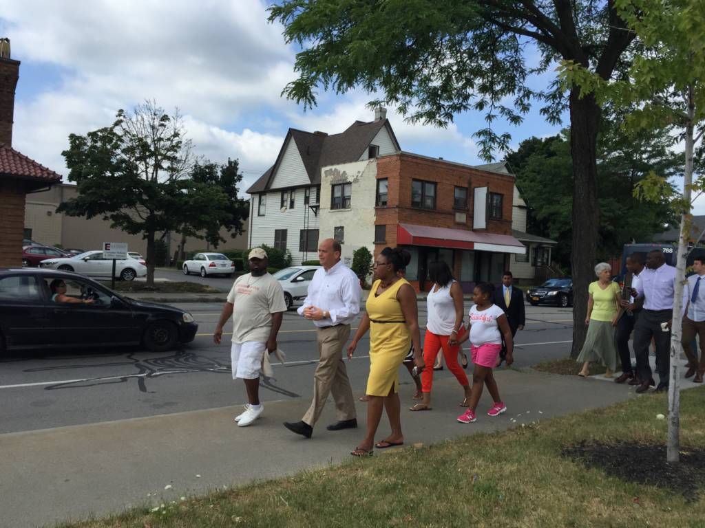 Tom Reed visiting Rochester, walking with Mayor Lovely Warren and residents