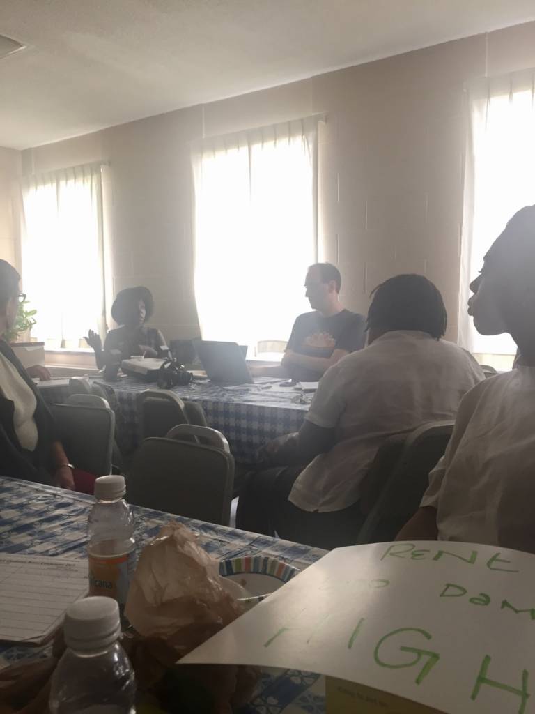Brunch attendees sit around tables discussing environmental justice issues