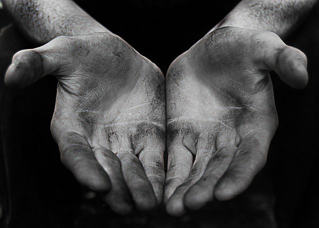 Hands with dirt on them held open