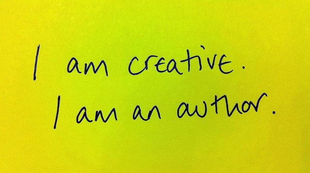 Yellow paper with black text saying "I am creative, I am an author."