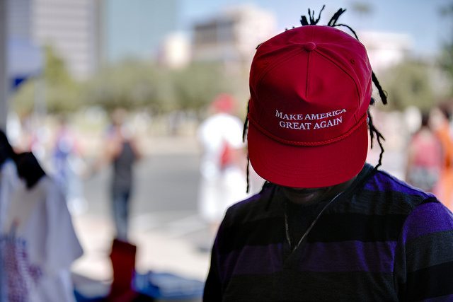 A man wears a "Make America Great Again" hat.