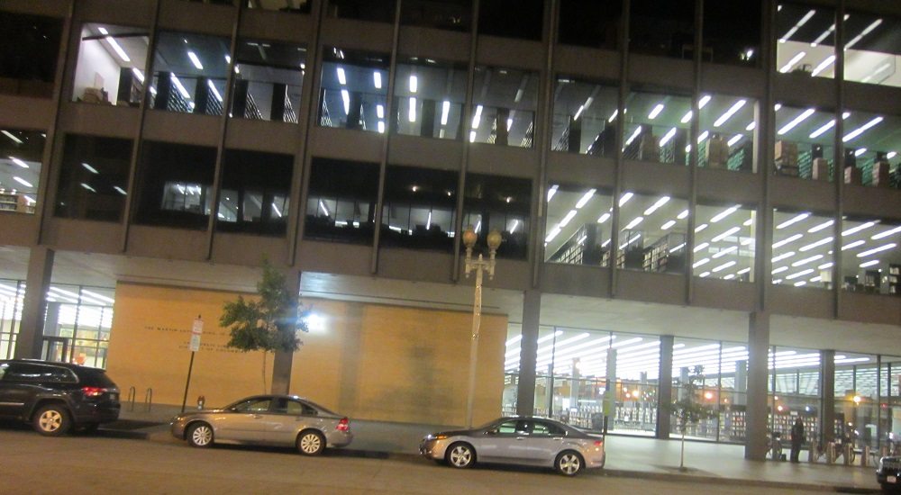 The front of the MLK Library at night.