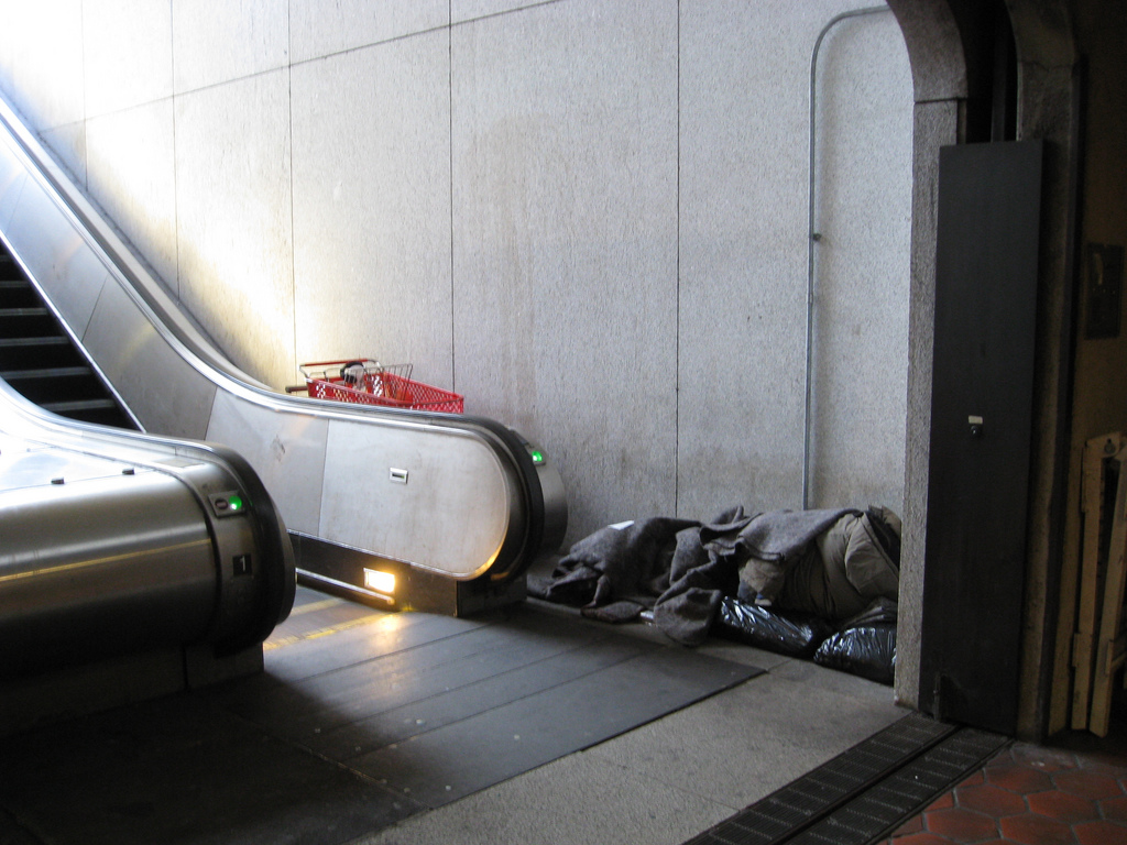 A homeless individual sleeps in a D.C. Metro station.