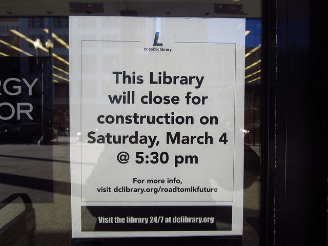 A sign taped to the window of the MLK Library that reads, "This Library will be closed for construction on Saturday, March 4 @ 5:30pm"