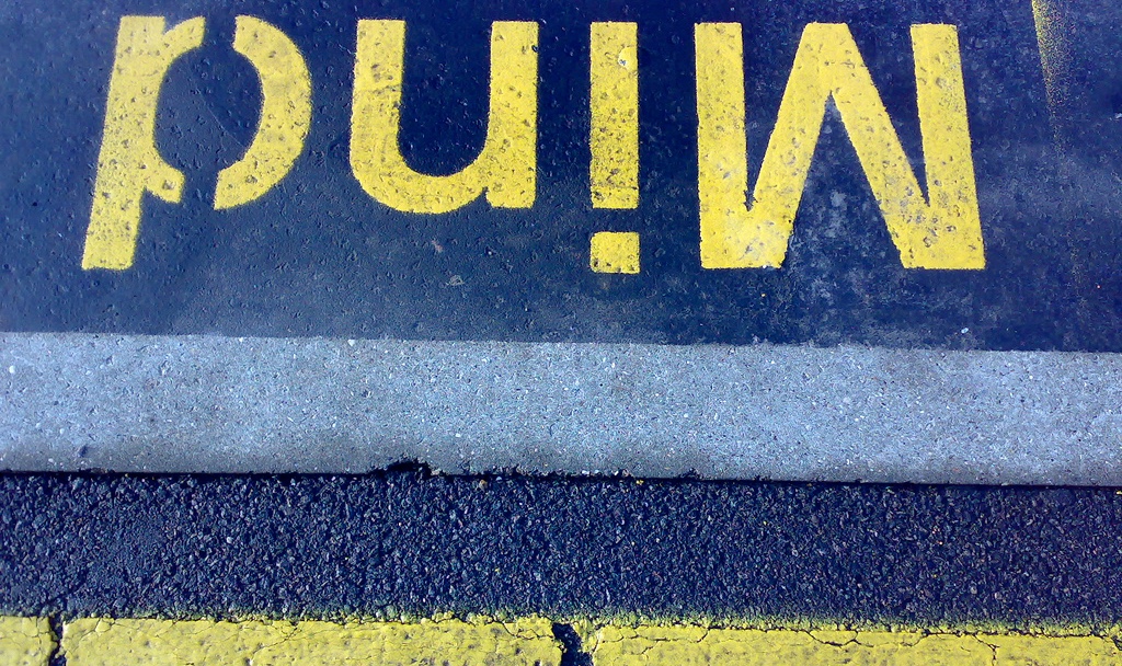 The word "mind" is painted on a street.
