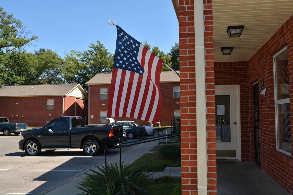 A photo of an American flag in front of a home.