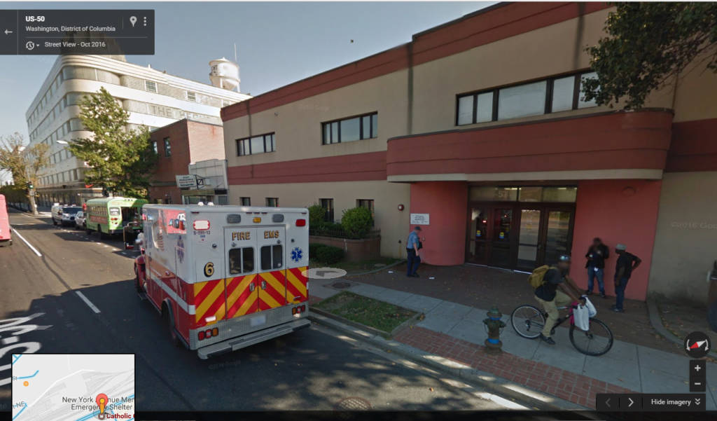 entrance to New York Ave shelter with an ambulance truck parked in the front of the building