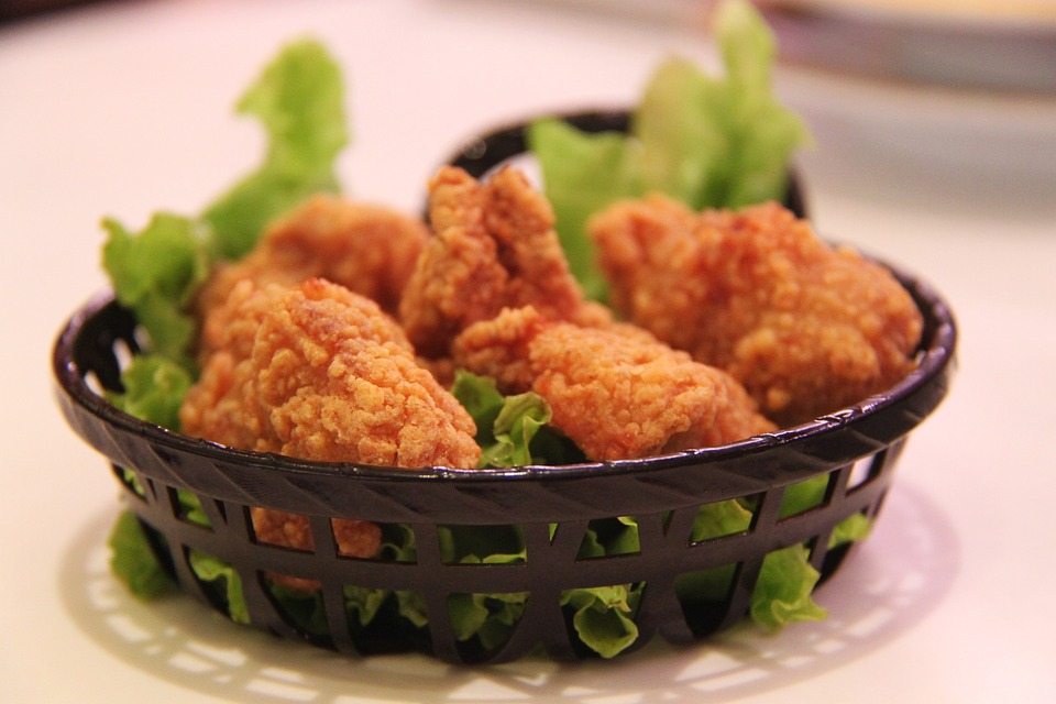 A photo of fried chicken in a basket.