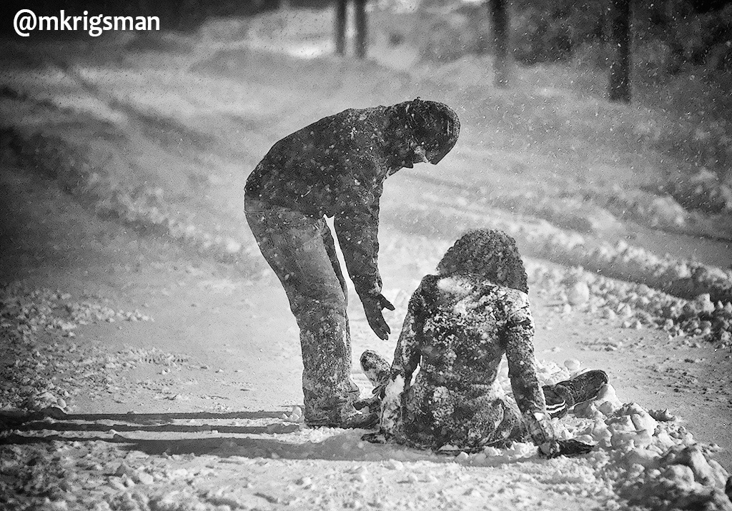 A Photo of a man Helping a lady up