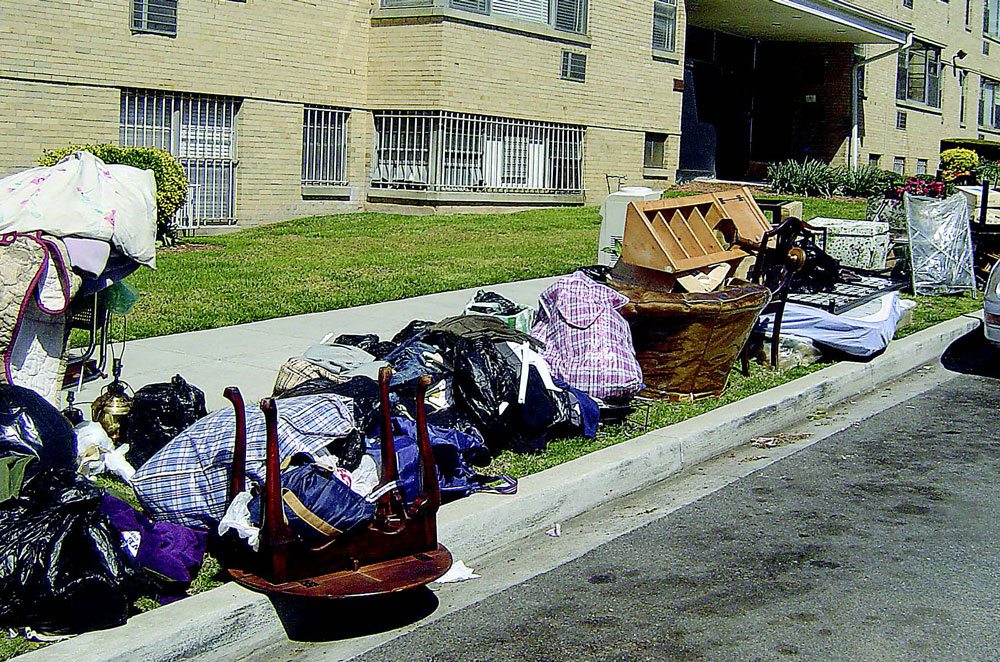 A photo of furniture and belongings on a curb on Tuckerman Street in Northwest. Homeless people were paid to move the items there, much as they have done at thousands of others apartments in D.C.