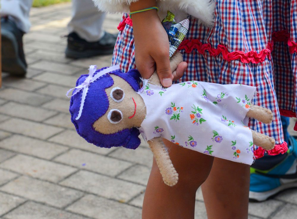 Photo of a girl holding a doll.